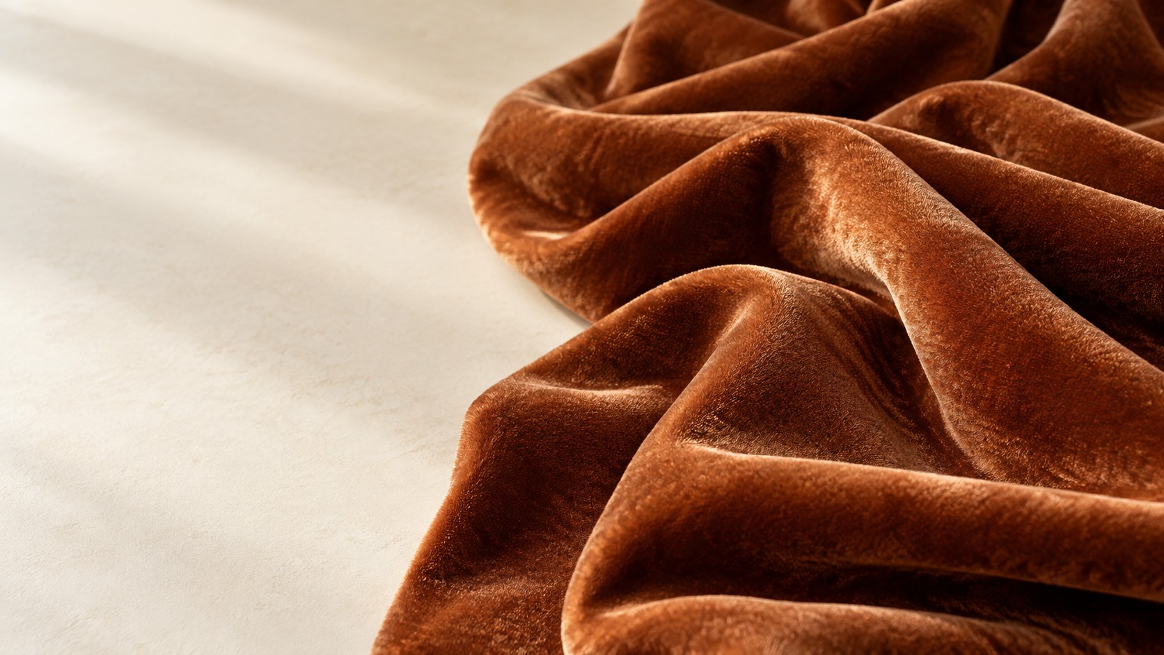 Copper velvet with soft folds and a rich, light-catching pile